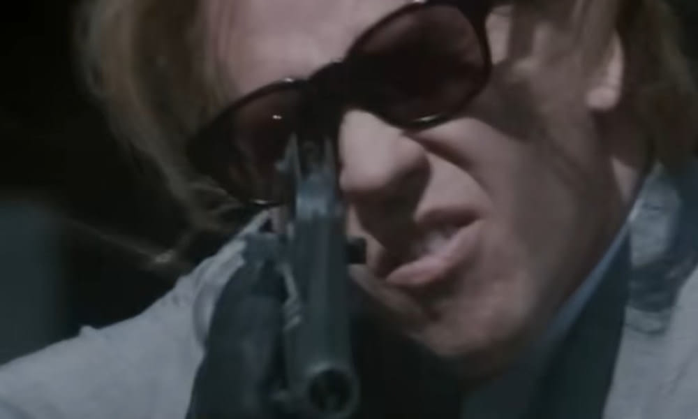 Chris (Val Kilmer) opens up with his Colt Model 733