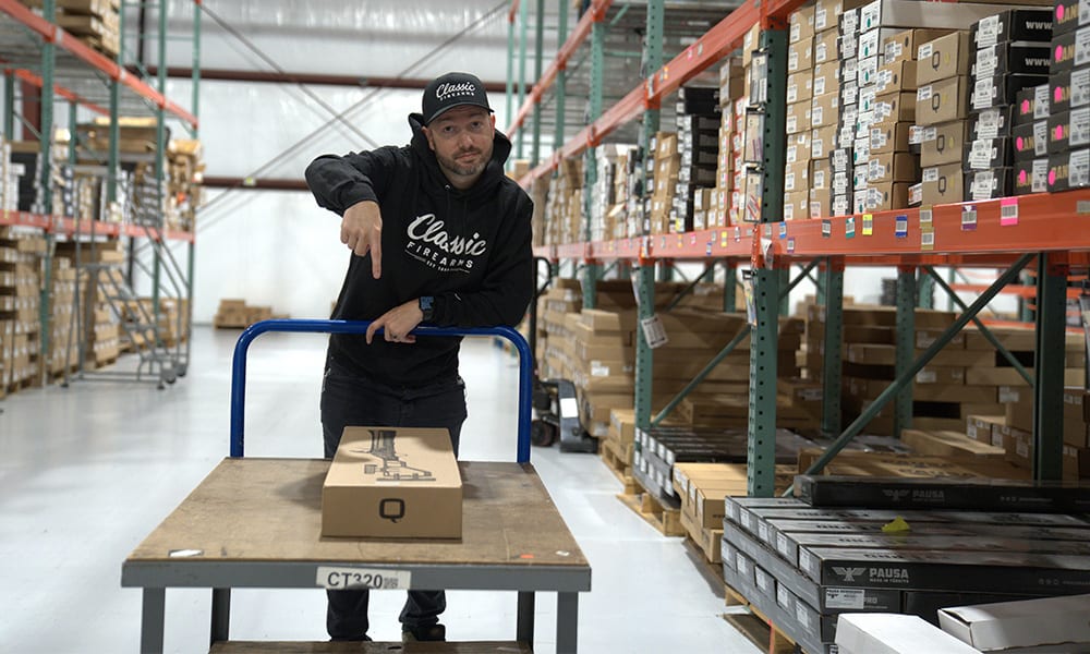 Josh pushing a cart with his selected firearm