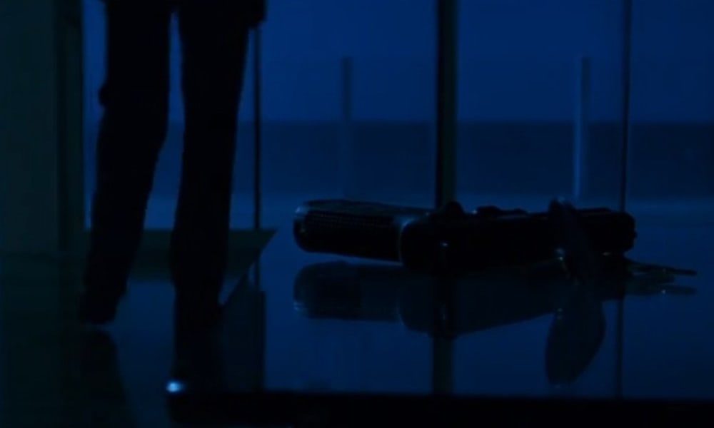Neil places his USP on a table after coming home